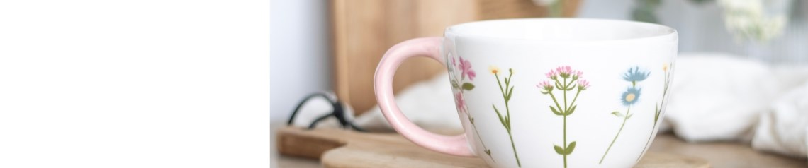 Blooming Lovely wholesale gift range featuring pastel floral designs on mugs, jugs, coasters, bath salts, seed balls, keyrings, candles, essential oils, picnic bags, and doormats. A charming selection of Mother's Day gifts and feminine home accessories ideal for garden centres, gift shops, and lifestyle retailers looking for nature-inspired stock.