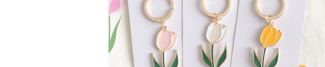 Wholesale Tulip Fields homeware collection with pastel tulip prints, ideal for spring and Mother's Day gifts. Features floral candles, enamel keyrings, kitchenware and tote bags. No minimum order, worldwide shipping available.